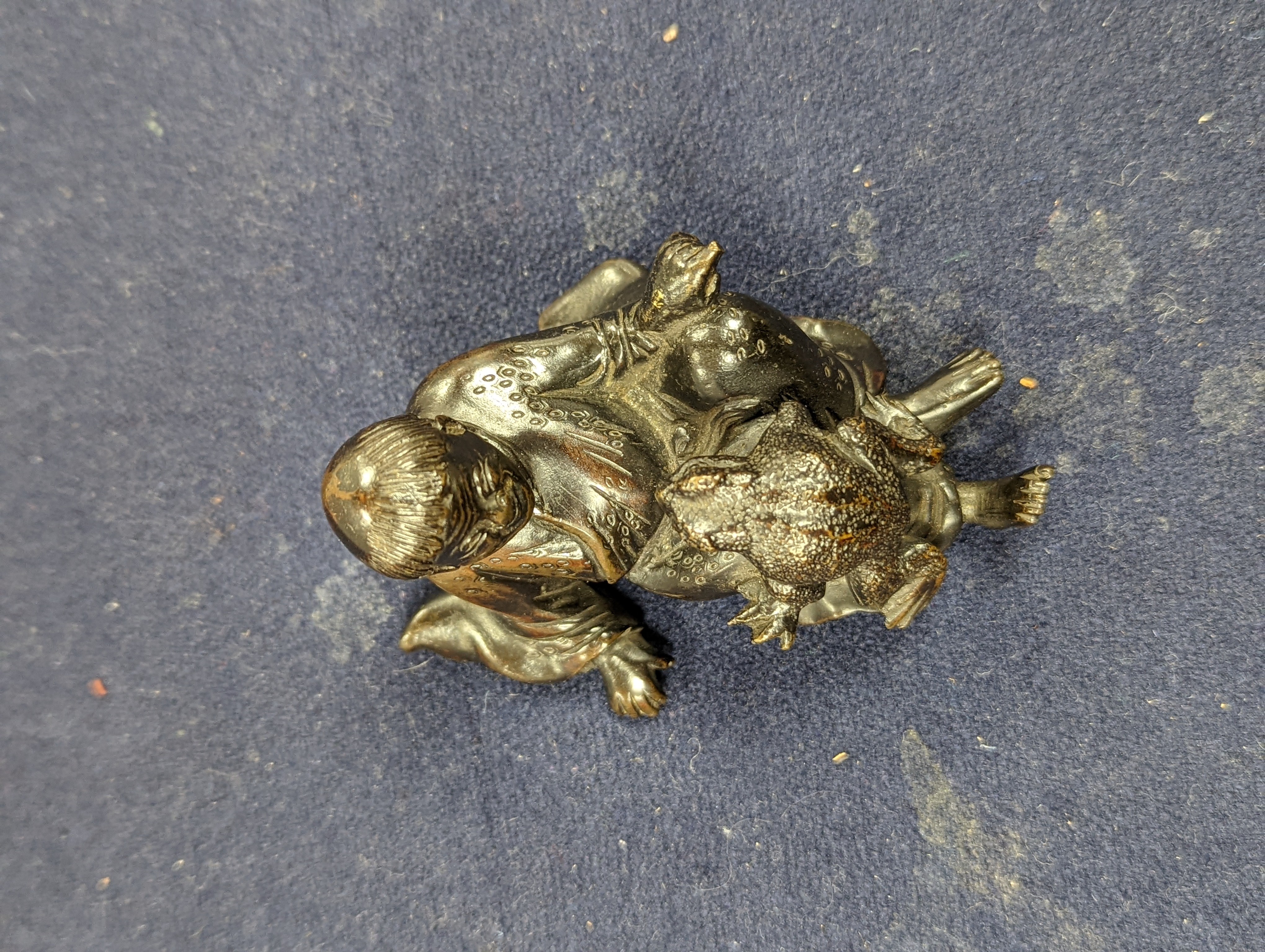 A Chinese bronze group of Liu Hai and a toad, wood stand and a bronze figure of a dog, 9cm